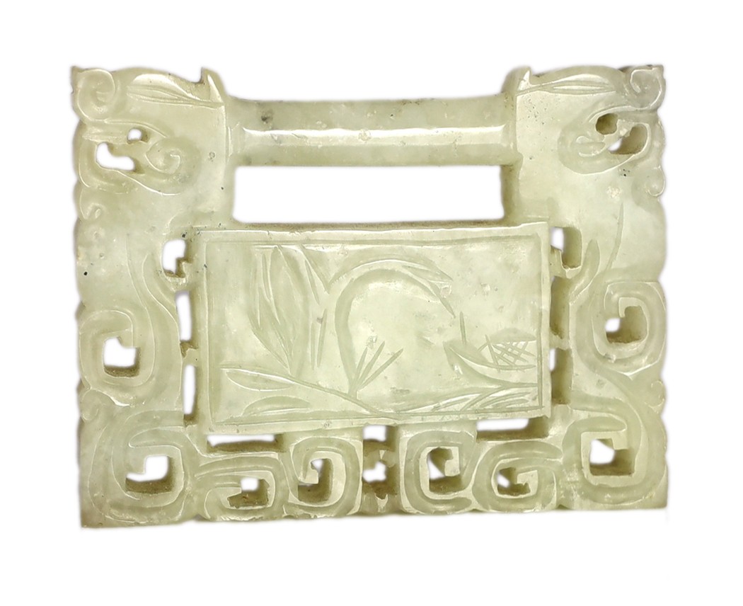 A Chinese speckled white jade ‘lock’ pendant plaque, 19th/20th century, 7.6cm x 5.8cm, wood stand